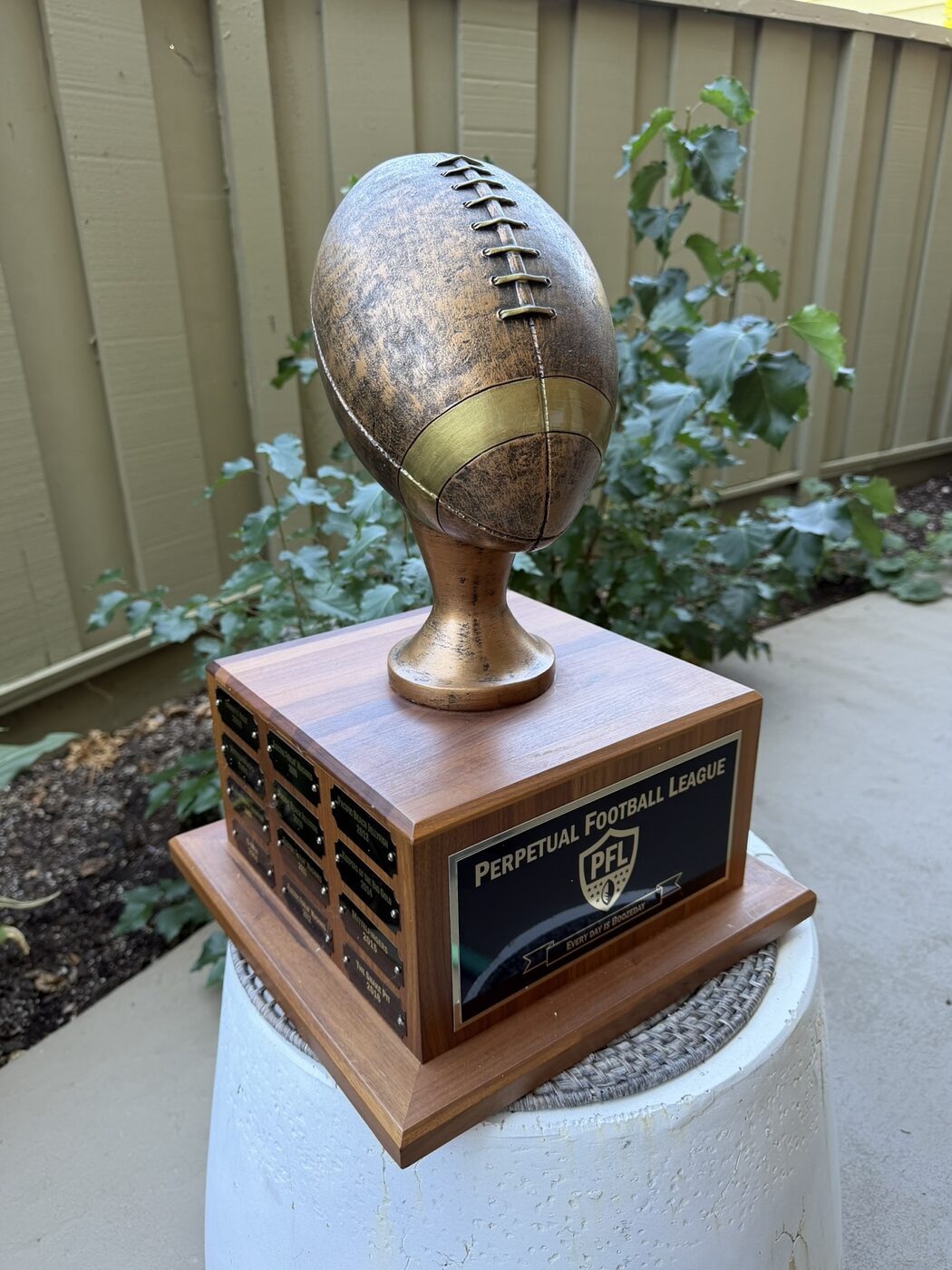 The PFL trophy: a bronze football on a walnut base with the Perpetual Football League nameplate